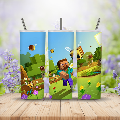 Three colourful tumblers with Minecraft-themed designs on a wooden surface. Miss Mafia