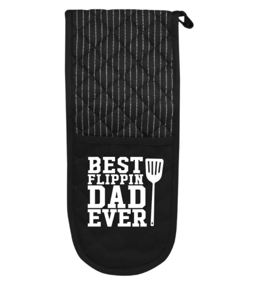 Black oven mitt with 'Best Flippin' Dad Ever' text and spatula graphic on a white background