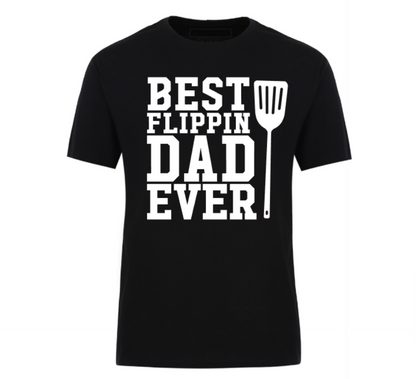 Black t-shirt with bold text “Best Flippin’ Dad Ever” featuring a spatula icon – ideal for dads who dominate the grill.
