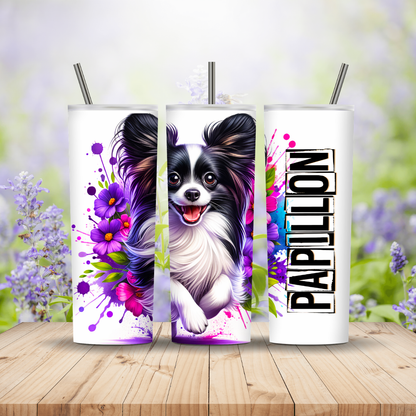 Three tumblers with a Papillon dog design on a wooden surface with a floral background.
