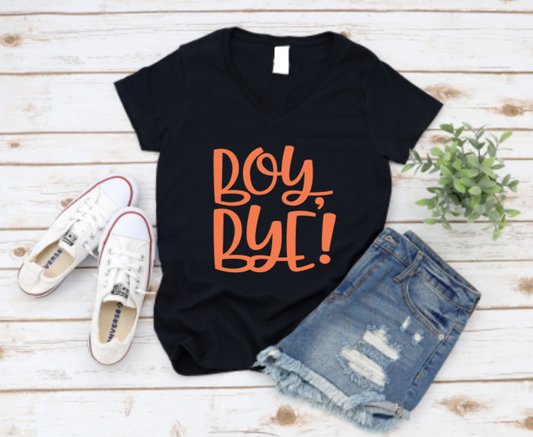 Black t-shirt with bold “Boy, Bye!” text, styled with ripped denim shorts and white Converse sneakers on a rustic white wood background.
