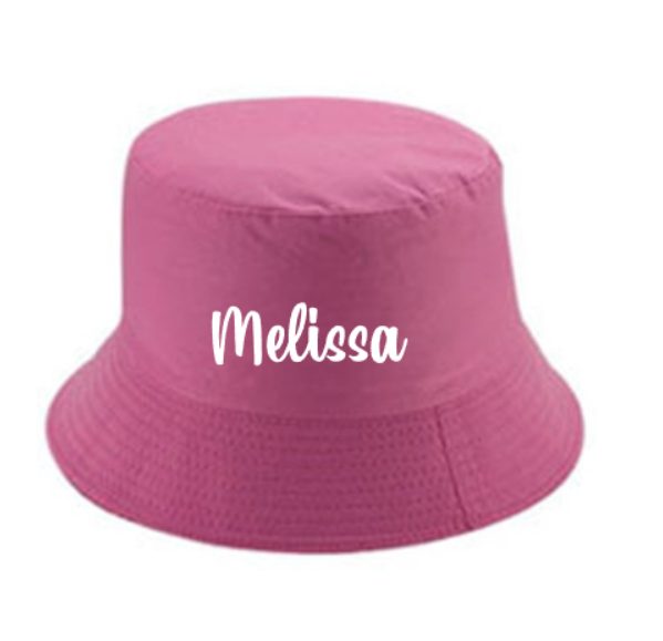 Pink bucket hat with 'Name' printed on it and the hat is on a white background