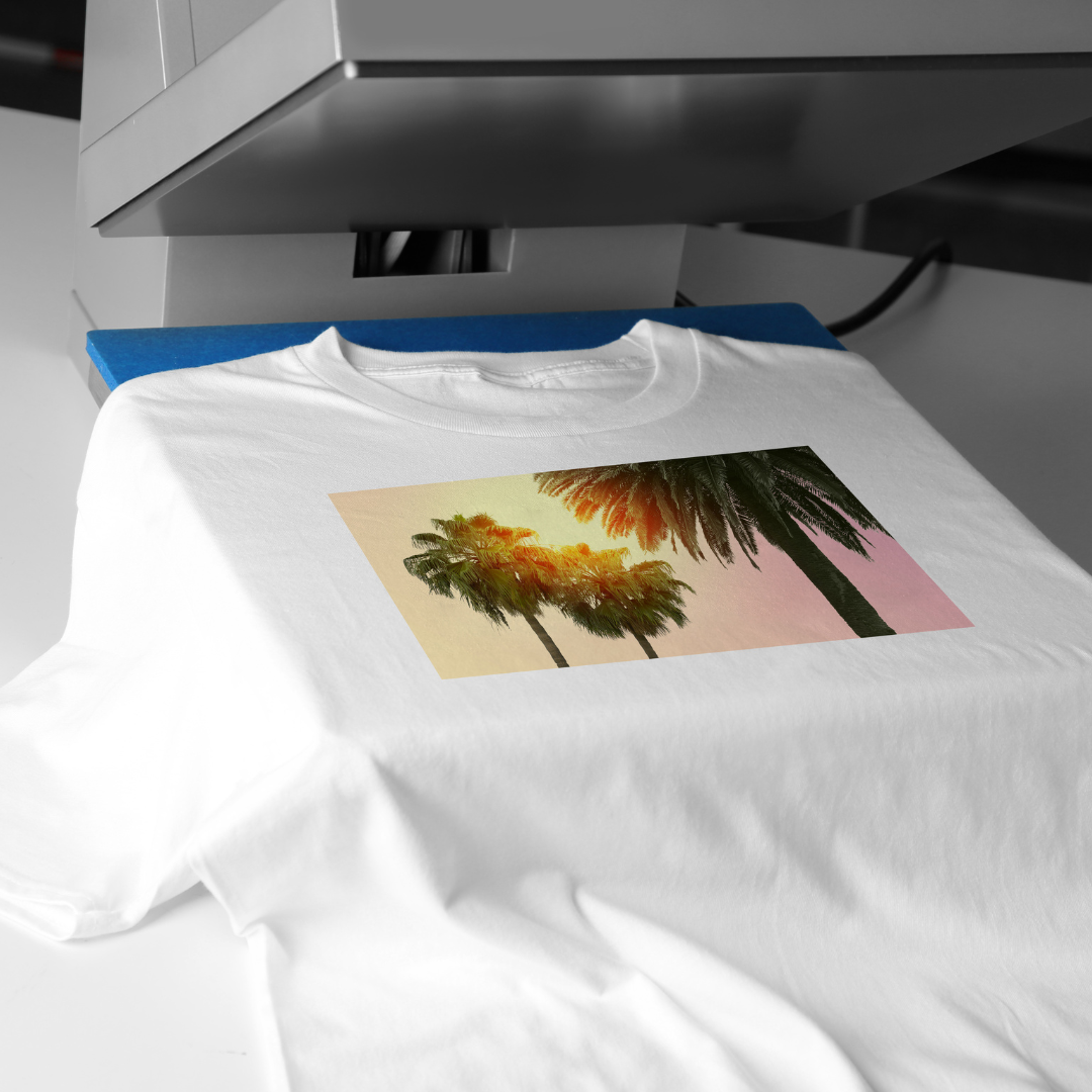 Image of a white shirt with a picture on it under a heat press