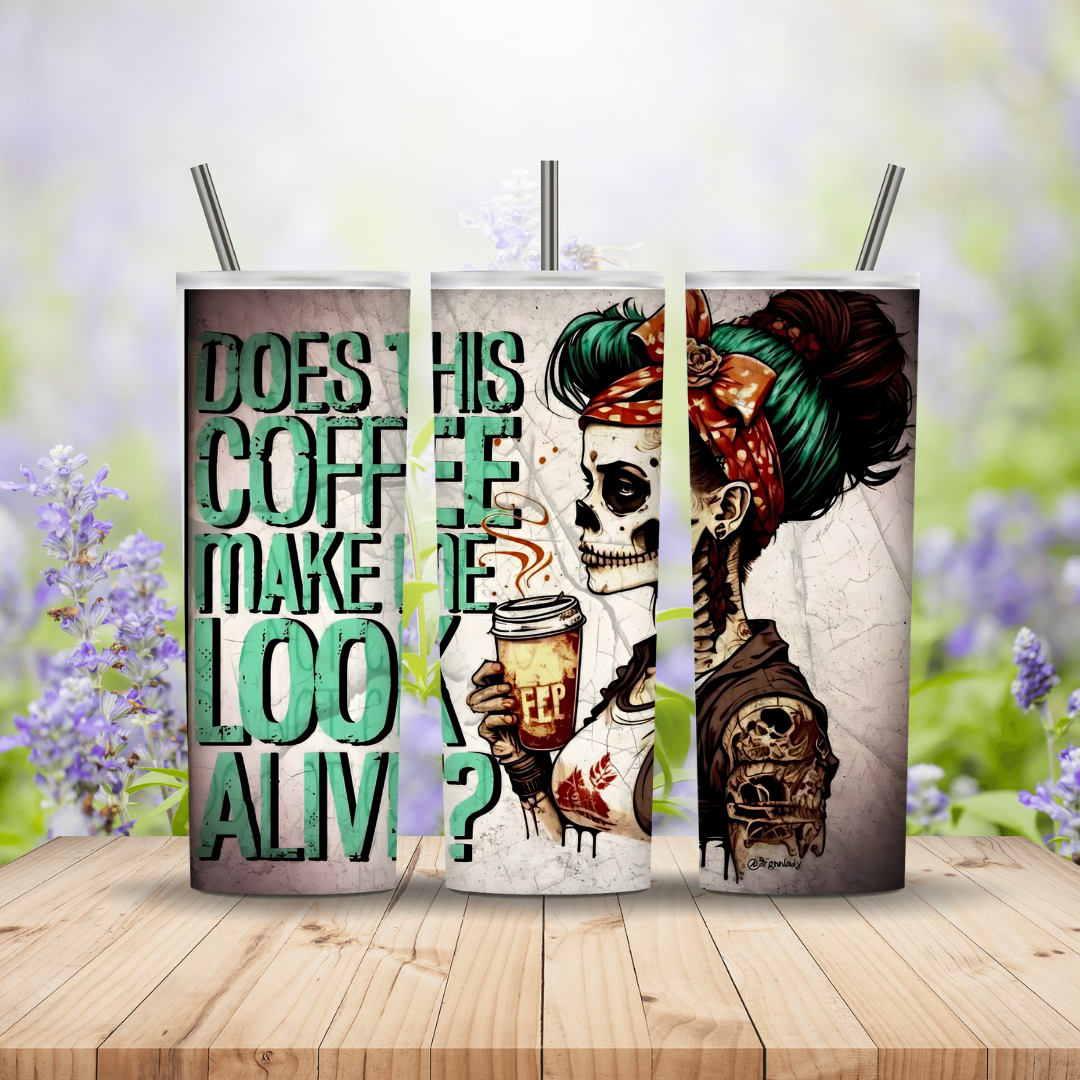 Three tumblers with skull designs and coffee-themed text on a wooden surface with a blurred floral background.