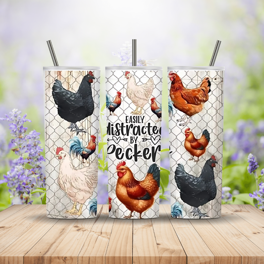 Three tumbler cups with chicken designs on a wooden surface with a blurred floral background.