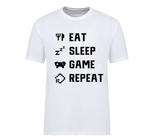 White t-shirt with white pixel-style text reading "Eat Sleep Game Repeat" alongside gaming and sleep icons, perfect for gamers.