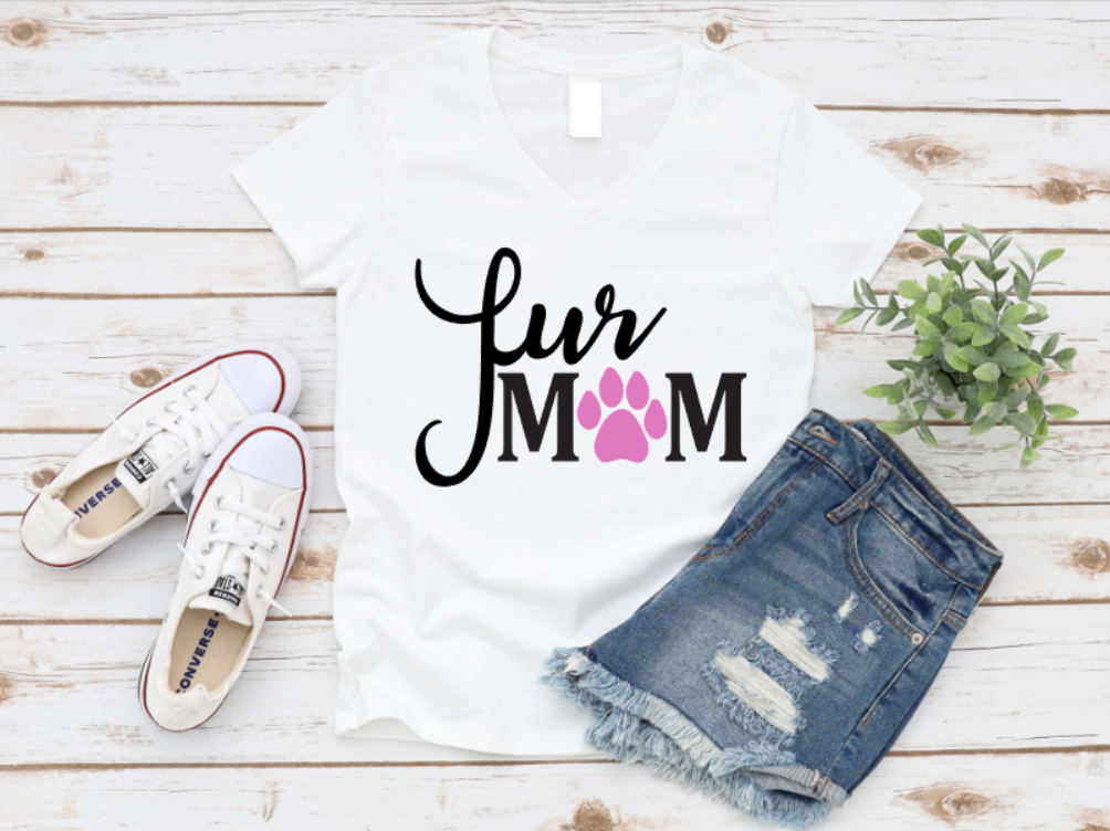 White v-neck t-shirt with the phrase "Fur Mum" in white and a pink paw print in place of the "O", styled flat lay with denim shorts and white Converse sneakers.