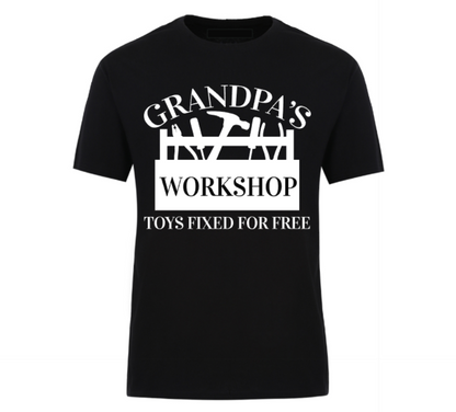 Black t-shirt with bold white text that reads “Grandpa’s Workshop – Toys Fixed for Free,” featuring tool graphics and a humorous handyman theme, perfect for grandads who love to tinker.
