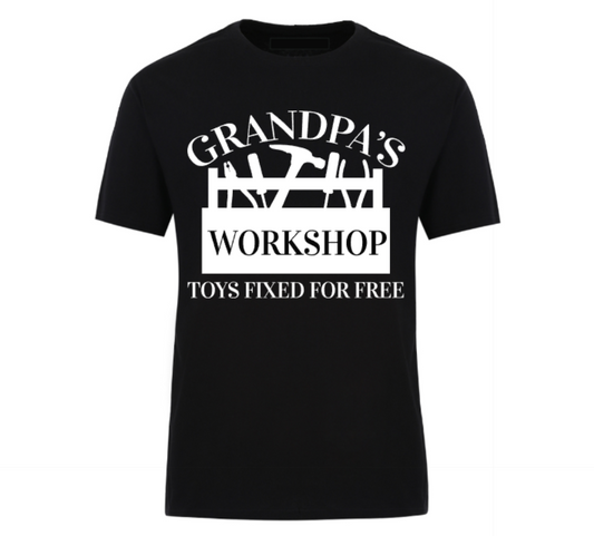 Black t-shirt with bold white text that reads “Grandpa’s Workshop – Toys Fixed for Free,” featuring tool graphics and a humorous handyman theme, perfect for grandads who love to tinker.