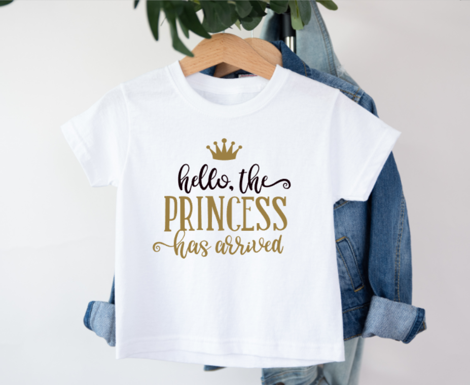 White t-shirt with 'hello, the princess has arrived' text on a hanger with denim jacket.