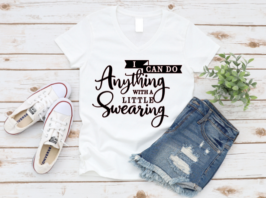 White t-shirt with humorous text, white sneakers, and denim shorts on a wooden surface.