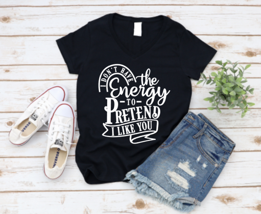 Black t-shirt with humorous text design on a wooden surface with shoes and shorts.