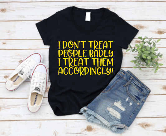 Black t-shirt with yellow text, white sneakers, and denim shorts on a wooden surface.