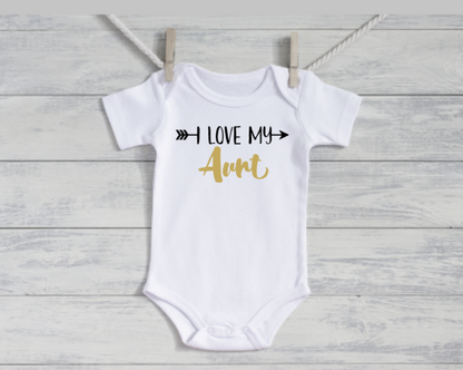 White baby onesie with 'I Love My Aunt' text on a wooden surface
