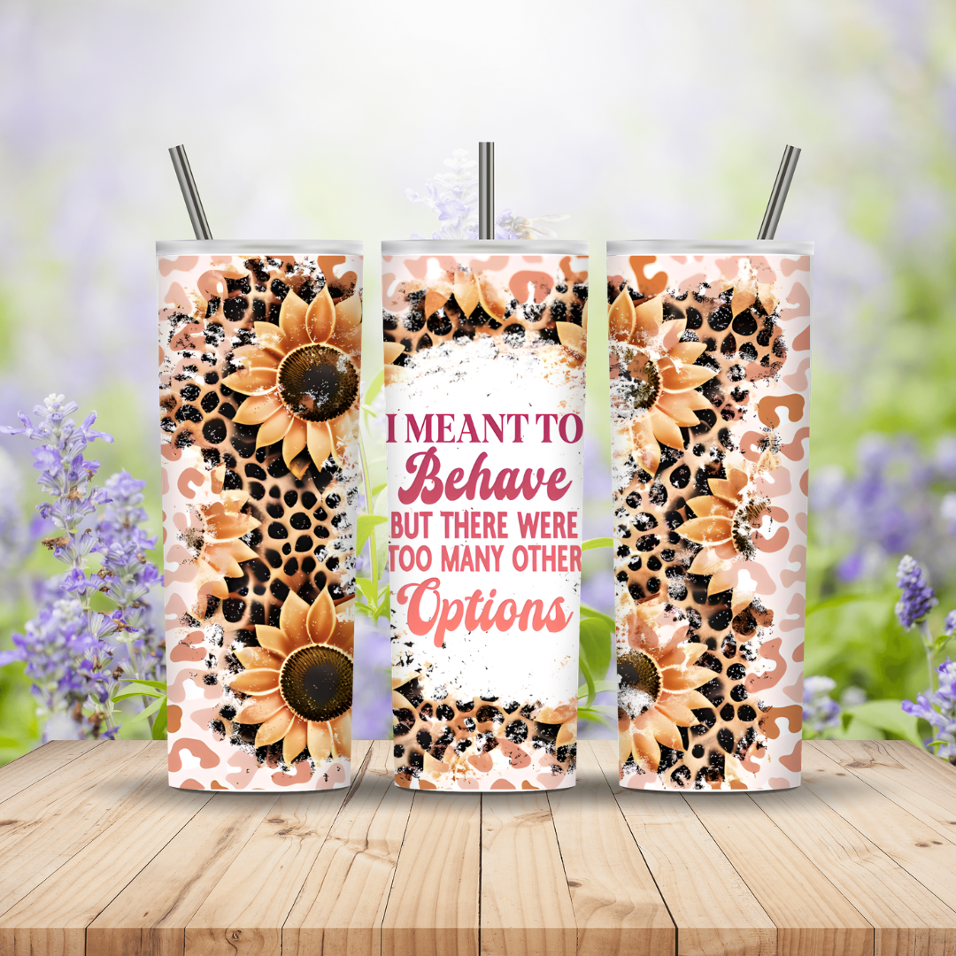Three sunflower-themed tumblers with straws on a wooden surface with a blurred floral background.