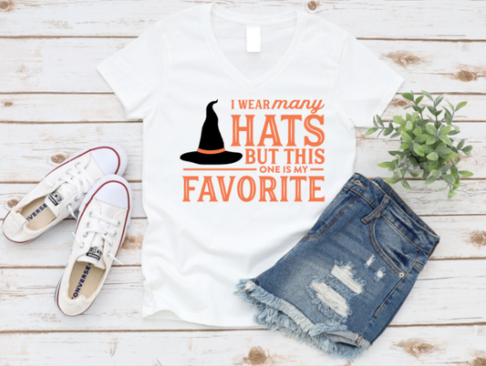 White t-shirt with a graphic and text, paired with denim shorts and white sneakers on a wooden surface. Shop at www.missmafia.com