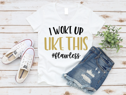 White t-shirt with 'I woke up like this #flawless' text, denim shorts, and white sneakers on a wooden surface. Shop at www.missmafia.com