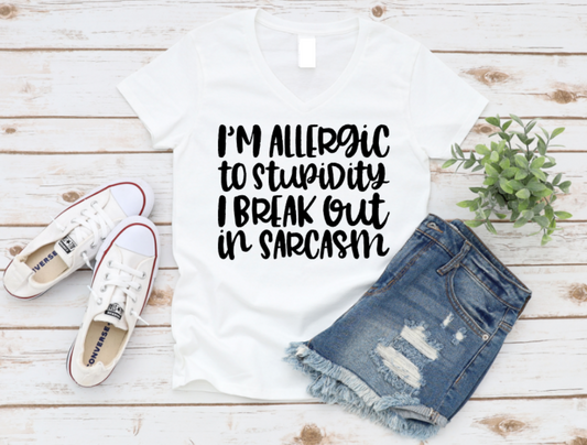T-shirt with humorous text, denim shorts, and sneakers on a wooden surface. Shop at www.missmafia.com