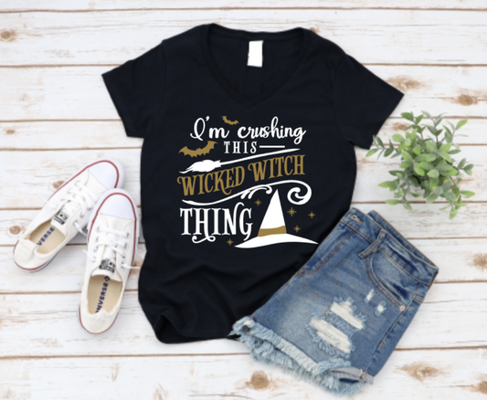 Black t-shirt with Halloween-themed text, white sneakers, and denim shorts on a wooden surface. shop www.missmafia.com