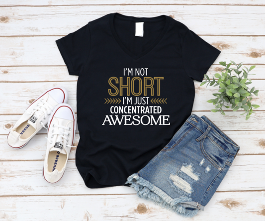 Black t-shirt with 'I'm not short, I'm just concentrated awesome' text on a wooden surface with shoes and shorts. www.missmafia.com