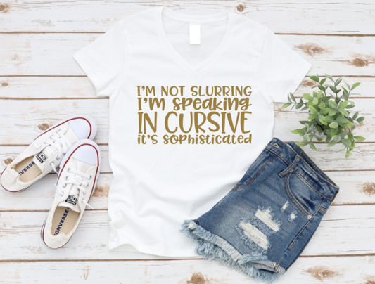 White t-shirt with humorous text, white sneakers, and denim shorts on a wooden surface. www.missmafia.com