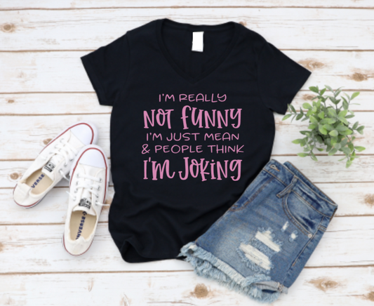 Black t-shirt with pink text, white sneakers, and denim shorts on a wooden surface www.missmafia.com