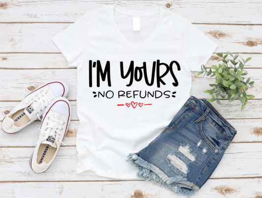 White t-shirt with 'I'm Yours No Refunds' text, denim shorts, and white sneakers on a wooden surface. www.missmafia.com
