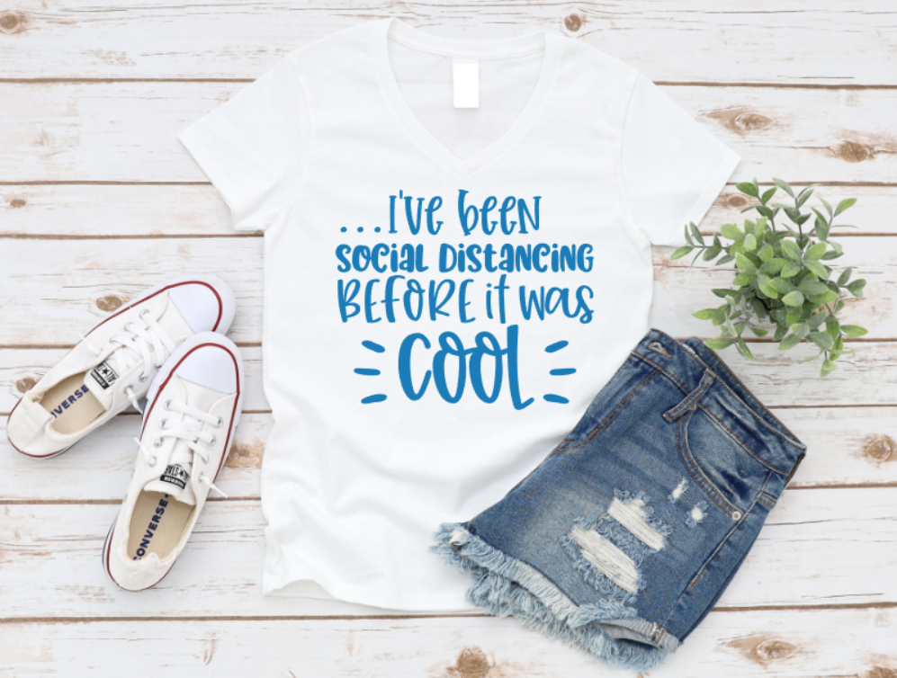 White t-shirt with humorous text, denim shorts, and white sneakers on a wooden surface. www.missmafia.com