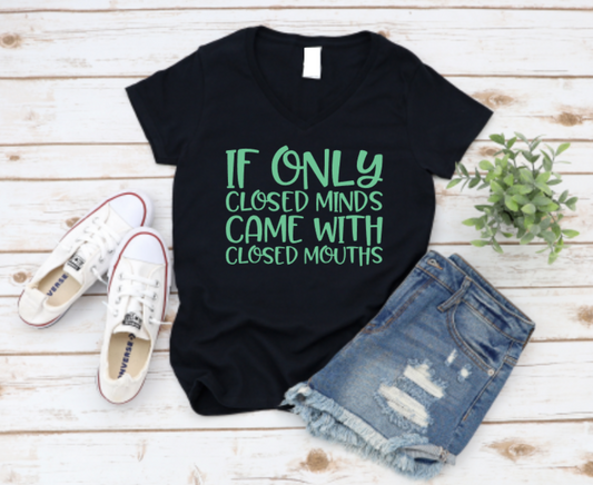 Black t-shirt with green text on a wooden surface with shoes and shorts. Shop now www.missmafia.com