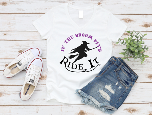 White t-shirt with 'If the broom fits, ride it' design, white sneakers, denim shorts, and a plant on a wooden surface. Shop now at www.missmafia.com