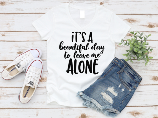 White t-shirt with 'It's a beautiful day to leave me alone' text, denim shorts, and white sneakers on a wooden surface. www.missmafia.com