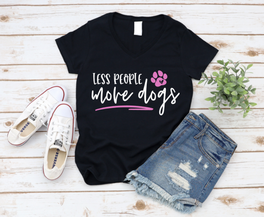 Black t-shirt with 'Less people, more dogs' text and paw print, paired with white sneakers and denim shorts on a wooden surface. www.missmafia.com