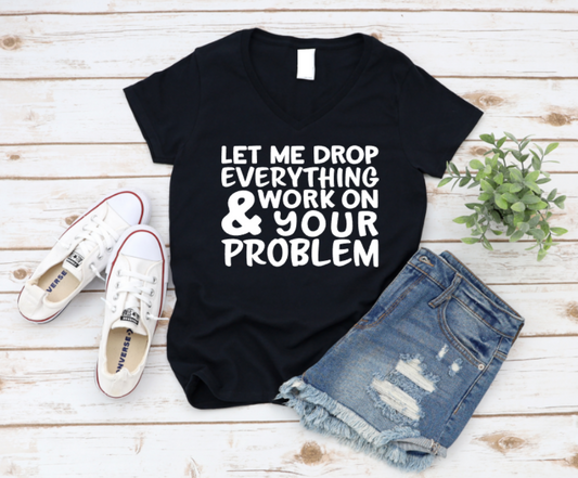 Black t-shirt with humorous text on a wooden surface with shoes and shorts. www.missmafia.com