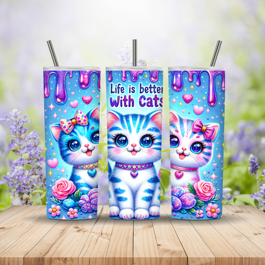 Three colorful tumblers with cartoon cats on a wooden surface with a floral background. Miss Mafia
