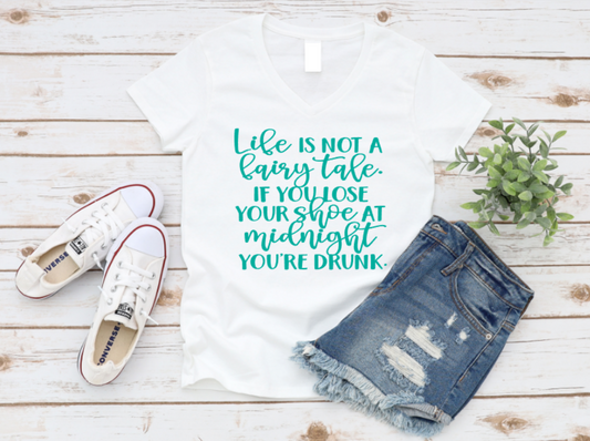 White t-shirt with humorous text, white sneakers, and denim shorts on a wooden surface. www.missmafia.com