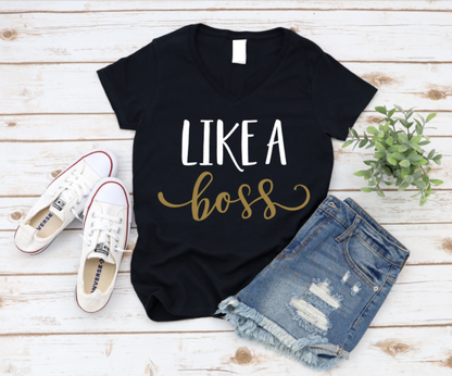 Black t-shirt with 'Like a boss' text, white sneakers, and denim shorts on a wooden surface. www.missmafia.com