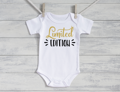 White baby onesie with 'Limited Edition' text on a wooden surface