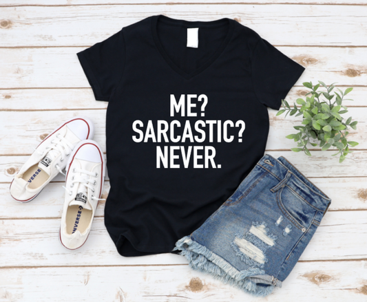 Black t-shirt with 'ME? SARCASTIC? NEVER.' text, paired with denim shorts and white sneakers on a wooden surface. www.missmafia.com