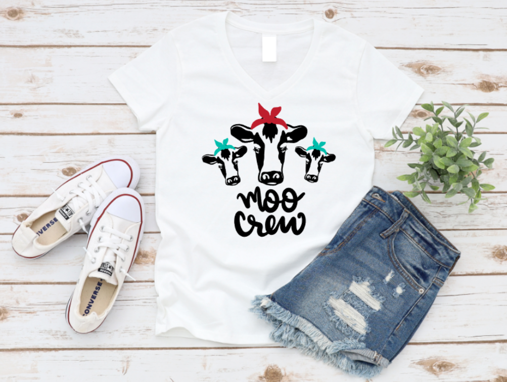 White t-shirt with 'Moo Crew' design, white sneakers, and denim shorts on a wooden surface. www.missmafia.com