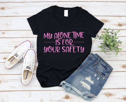 Black t-shirt with pink text 'My alone time is for your safety' on a wooden surface with shoes and shorts. www.missmafia.com