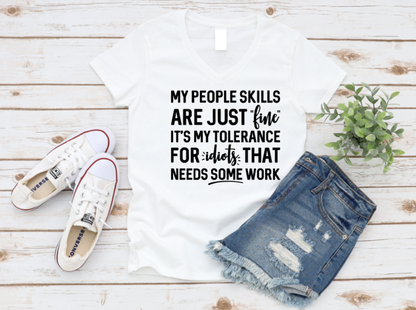 White t-shirt with humorous text, white sneakers, and denim shorts on a wooden surface. www.missmafia.com