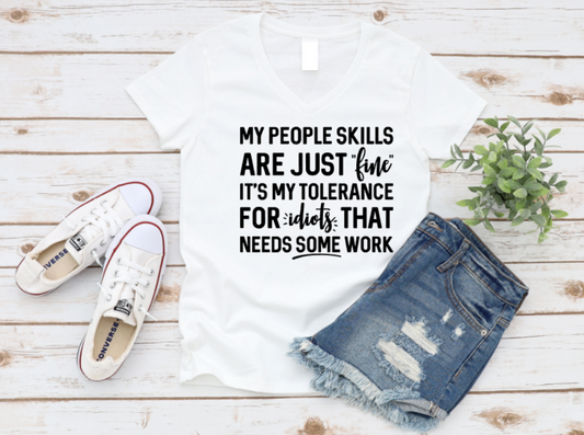 White t-shirt with humorous text, white sneakers, and denim shorts on a wooden surface. www.missmafia.com
