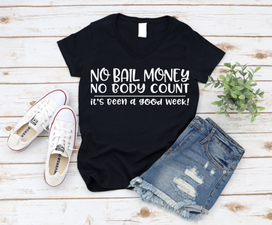 Black t-shirt with humorous text, paired with jeans and sneakers on a wooden surface. www.missmafia.com