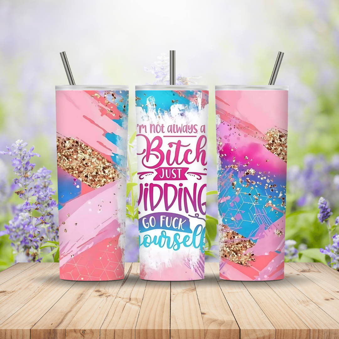 Three colorful tumblers with glittery designs and text on a wooden surface with a blurred floral background.