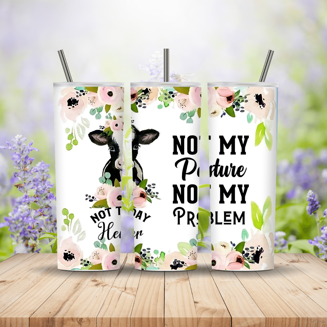 Three tumblers with floral designs and text on a wooden surface with a blurred natural background