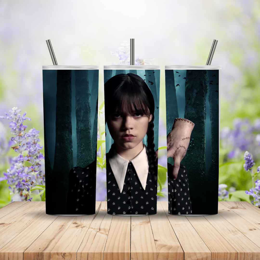 Three tumblers with a design of a character from a movie or TV show on a wooden surface with a blurred floral background.