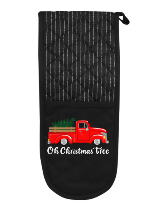 Black oven mitt with red truck and Christmas tree design on a white background