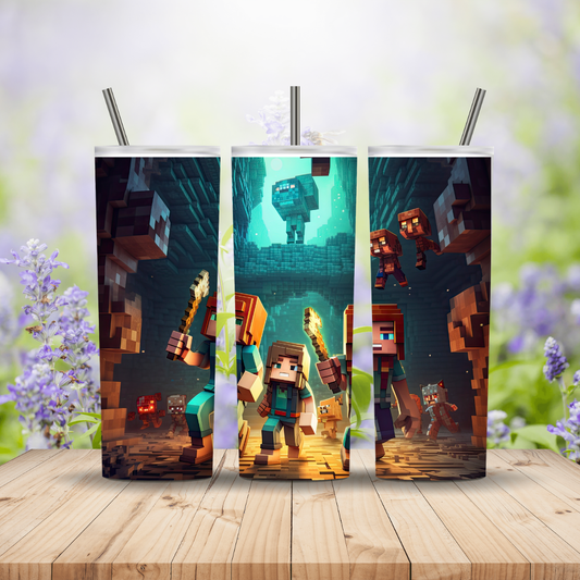 Three tumblers with Minecraft-themed designs on a wooden surface with flowers in the background. Miss Mafia