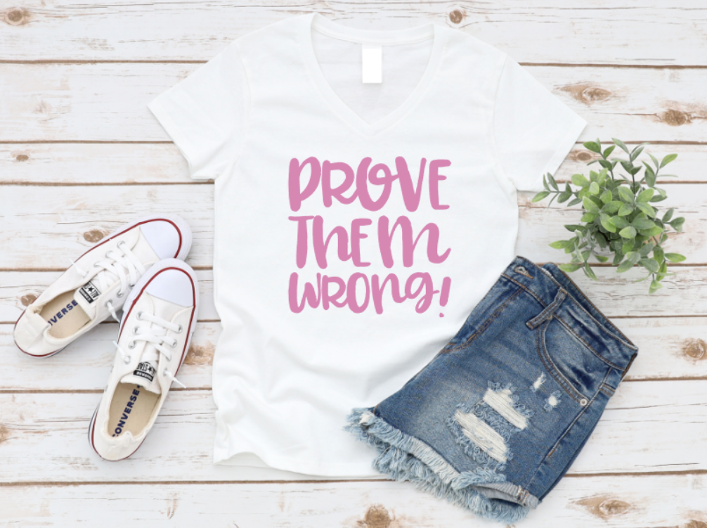 White t-shirt with 'PROVE THEM WRONG!' text, white sneakers, and denim shorts on a wooden surface.  www.missmafia.com