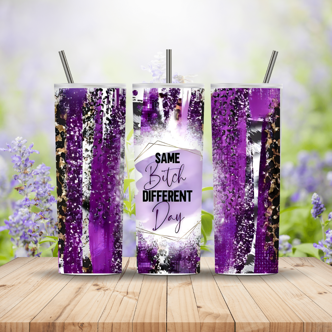 Three purple-themed tumblers with a humorous message on a wooden surface with a blurred floral background.